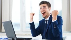 Broker working on laptop after closing deal